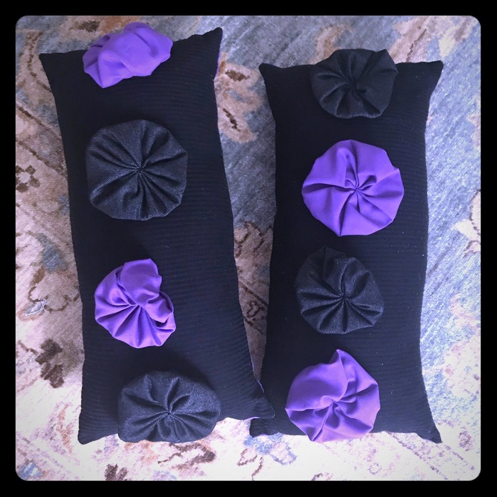 Two black and purple floral long pillows